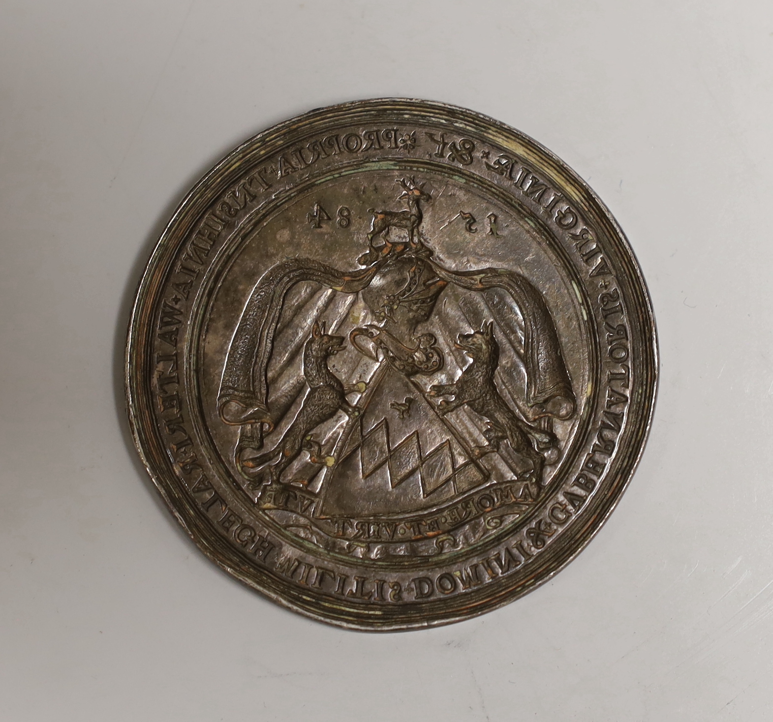 A circular silver seal-matrix of Sir Walter Raleigh, recast and subscriber issued by Crichton’s, c.1900, stamped no. 418 of an edition of 600, 55mm